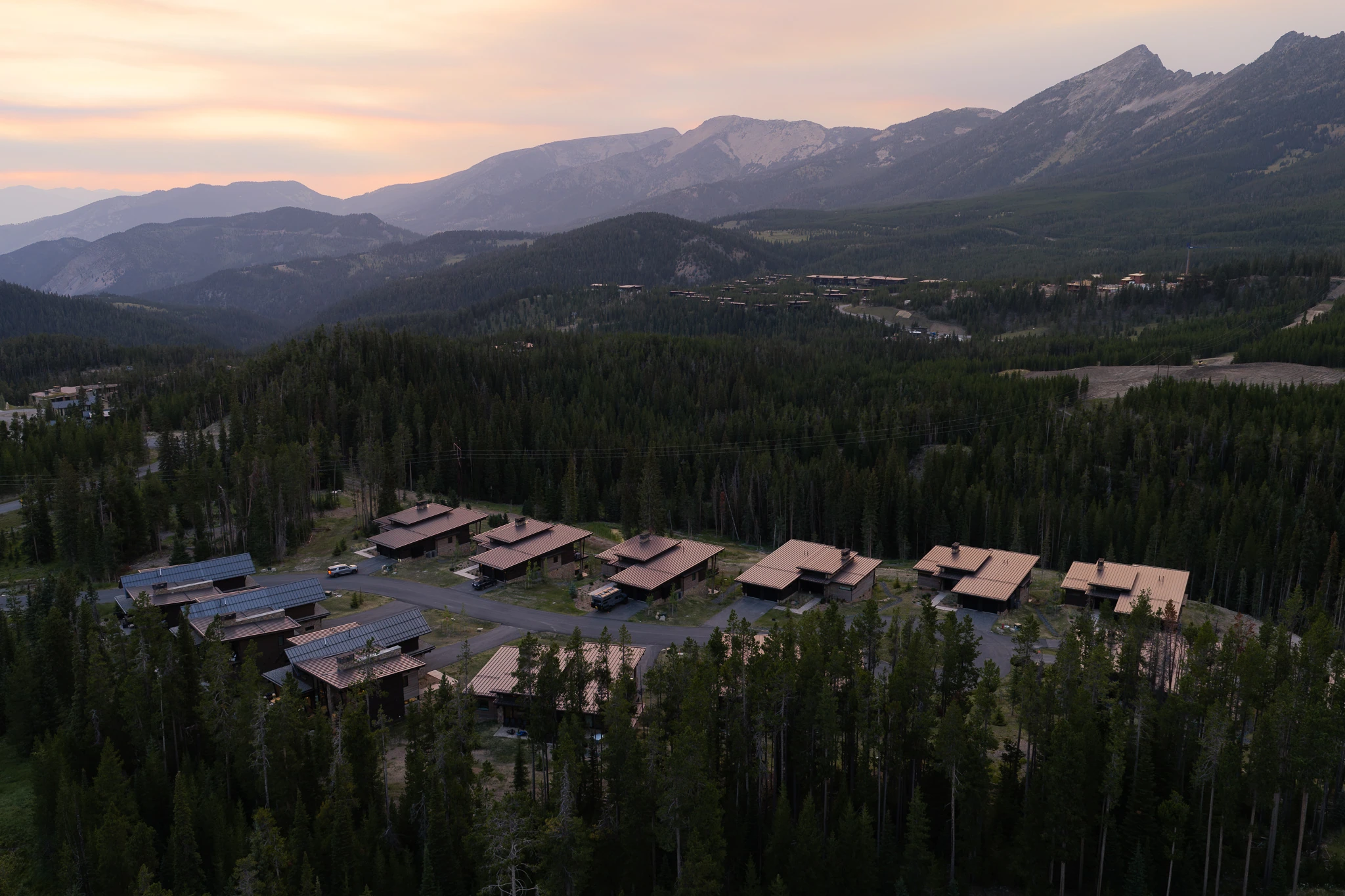 Aerial view of Moonlight Basin cabins at dusk — architectural photography Big Sky Montana, Reid Smith Architects